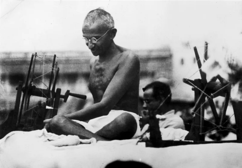 Gandhi at his spinning wheel in Mirzapur, 9 June 1925.