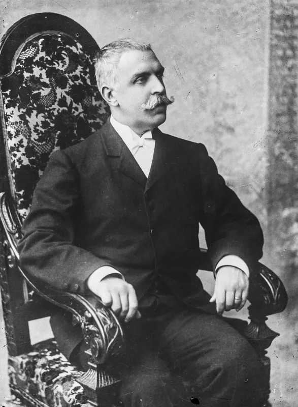 Manuel González Prada, seated, photographed in Lima about 1902.